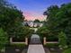 Impressive gated home with a long driveway lined with lush trees and landscaping at 11101 Hawthorn Rdg, Fishers, IN 46037