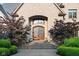 Close-up of the arched front door with decorative glass and stone steps at 11101 Hawthorn Rdg, Fishers, IN 46037