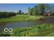 Scenic golf course view with a pond, bridge, and lush landscaping at 11101 Hawthorn Rdg, Fishers, IN 46037