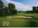 Picturesque view of a golf course featuring lush greenery, a sand trap, and clear blue skies at 11101 Hawthorn Rdg, Fishers, IN 46037