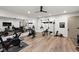 Well equipped home gym showcasing Peloton equipment and a full wall of mirrors at 11101 Hawthorn Rdg, Fishers, IN 46037