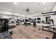 Fully equipped home gym featuring a treadmill, weights, mirrors, and wood flooring at 11101 Hawthorn Rdg, Fishers, IN 46037