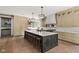Spacious kitchen featuring a large center island with barstool seating, custom cabinets, and modern appliances at 11101 Hawthorn Rdg, Fishers, IN 46037