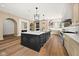 An open-concept kitchen with a large center island, pendant lighting, and hardwood floors, ideal for entertaining at 11101 Hawthorn Rdg, Fishers, IN 46037