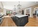 Stylish kitchen with a spacious center island, hardwood floors, and arched openings to adjacent rooms at 11101 Hawthorn Rdg, Fishers, IN 46037