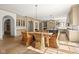 Open-concept kitchen and dining area featuring hardwood floors, a large kitchen island, and a nearby dining table at 11101 Hawthorn Rdg, Fishers, IN 46037