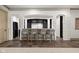 Basement kitchenette with bar seating, white stone accents and a door to a temperature controlled wine cellar at 11101 Hawthorn Rdg, Fishers, IN 46037