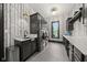 Modern laundry room features stylish wallpaper, dark cabinetry, and gray tile flooring at 11101 Hawthorn Rdg, Fishers, IN 46037