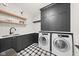 Well-appointed laundry room with modern appliances, custom cabinets, and stylish tile flooring at 11101 Hawthorn Rdg, Fishers, IN 46037