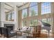 Bright living room with a fireplace, tall windows, and a grand piano at 11101 Hawthorn Rdg, Fishers, IN 46037