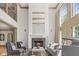 Elegant living room featuring a fireplace, tall windows and neutral decor at 11101 Hawthorn Rdg, Fishers, IN 46037