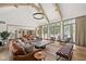 Expansive living room boasts soaring ceilings with exposed beams, flooded with natural light from large windows at 11101 Hawthorn Rdg, Fishers, IN 46037