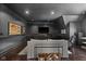 Dark painted living room with sleek media center, modern decor, and hardwood flooring offers comfortable seating at 11101 Hawthorn Rdg, Fishers, IN 46037