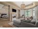 Comfortable living room with a fireplace, and a seamless transition to the adjacent main bedroom and office space at 11101 Hawthorn Rdg, Fishers, IN 46037