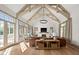 Bright living room featuring vaulted ceilings, exposed beams, a brick fireplace, and ample natural light at 11101 Hawthorn Rdg, Fishers, IN 46037
