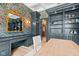Home office with built-in shelving, writing desk, floral wallpaper, and access to walk-in closet at 11101 Hawthorn Rdg, Fishers, IN 46037