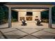 Cozy outdoor seating area with a fireplace, television, and stylish chairs at 11101 Hawthorn Rdg, Fishers, IN 46037