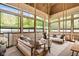 Serene sunroom featuring hanging swing chairs, neutral tones, and a peaceful ambiance with verdant view at 11101 Hawthorn Rdg, Fishers, IN 46037