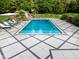 Backyard pool featuring a slide, lounge chairs, and manicured landscaping at 11101 Hawthorn Rdg, Fishers, IN 46037