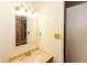 Bathroom vanity featuring a basin sink and a large, decorative mirror at 1113 Delray Dr, Indianapolis, IN 46241