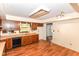 A kitchen area features wood cabinets, linoleum flooring, and a window above the sink at 1113 Delray Dr, Indianapolis, IN 46241