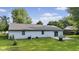 Wide backyard with patio, green grass, and mature trees at 1121 Barcelona Dr, Greenwood, IN 46143