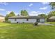 A well-maintained backyard featuring a lush lawn, patio area, and serene landscaping at 1121 Barcelona Dr, Greenwood, IN 46143
