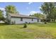 A spacious backyard with a well-maintained lawn, a patio, and mature trees creating a peaceful outdoor space at 1121 Barcelona Dr, Greenwood, IN 46143