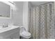 Bathroom featuring white vanity with sink, toilet, and shower with patterned curtain at 1121 Barcelona Dr, Greenwood, IN 46143