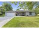 Charming single-story home with a well-manicured lawn and inviting front porch at 1121 Barcelona Dr, Greenwood, IN 46143