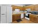 Kitchen features wooden cabinets, white appliances, and modern lighting fixtures at 1121 Barcelona Dr, Greenwood, IN 46143
