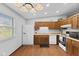 Bright kitchen features wooden cabinets, white appliances, and vinyl flooring at 1121 Barcelona Dr, Greenwood, IN 46143