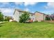 Expansive backyard view featuring a lush green lawn, and a cozy ground-level deck, ideal for relaxation and outdoor activities at 11849 Traymoore Dr, Fishers, IN 46038