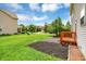 Well-maintained backyard with green lawn, trees, and brick patio at 11849 Traymoore Dr, Fishers, IN 46038