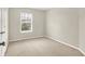 This bedroom has a window providing ample natural light and neutral carpeting at 11849 Traymoore Dr, Fishers, IN 46038