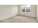 This bedroom has a window providing ample natural light and neutral carpeting at 11849 Traymoore Dr, Fishers, IN 46038