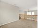 Carpeted upstairs hallway with wooden railing overlooking the lush backyard at 11849 Traymoore Dr, Fishers, IN 46038
