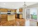Eat in kitchen featuring hardwood floors, wood cabinets, granite countertops, and stainless steel appliances at 11849 Traymoore Dr, Fishers, IN 46038