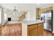 Open concept kitchen with island, stainless steel appliances, and view to adjacent living area at 11849 Traymoore Dr, Fishers, IN 46038