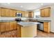 Updated kitchen featuring wood cabinets, stainless steel appliances, and functional center island at 11849 Traymoore Dr, Fishers, IN 46038