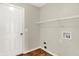 Well-lit laundry room with wood-look flooring and shelving at 11849 Traymoore Dr, Fishers, IN 46038