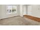 Neutral room featuring a large window, carpet, hardwood, a white door, and a white closet door at 11849 Traymoore Dr, Fishers, IN 46038