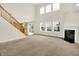 Inviting living room features a fireplace, large windows, neutral carpeting, and an open floorplan at 11849 Traymoore Dr, Fishers, IN 46038