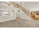 Open-concept living area with staircase, neutral tones, and great flow to other rooms at 11849 Traymoore Dr, Fishers, IN 46038