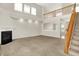Bright living room with a fireplace, large windows, staircase and an open floor plan perfect for entertaining at 11849 Traymoore Dr, Fishers, IN 46038