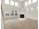 Spacious living room with fireplace, large windows offering abundant natural light and neutral carpeting at 11849 Traymoore Dr, Fishers, IN 46038