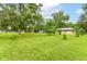 Lush backyard featuring mature trees and a shed at 1248 Hathaway Dr, Indianapolis, IN 46229