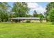 A large backyard with green grass and the rear exterior of the home at 1248 Hathaway Dr, Indianapolis, IN 46229