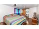 Comfortable bedroom with a colorful bedspread and a sliding barn door leading to the bathroom at 1248 Hathaway Dr, Indianapolis, IN 46229