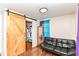 Cozy bedroom featuring a sliding barn door closet and a comfortable black futon at 1248 Hathaway Dr, Indianapolis, IN 46229